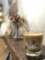 milk coffee with ice cubes and straws on the table photo