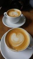 milk coffee with heart shape from milk with motion blur photo