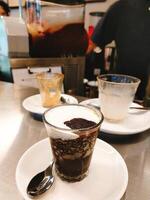 milk coffee with ice cream with two empty cups on the table photo