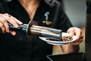 coffee beans are processed by coffee tools on a plate