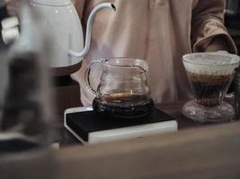 black coffee in a clear teapot with motion blur photo