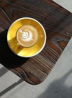 coffee milk with a tree shape in a yellow bowl photo