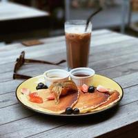 food with honey on a plate with chocolate milk photo