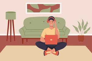 A young man wearing headphones with a laptop at home. Flat vector illustration