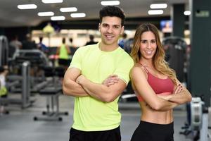 Man and woman personal trainers in the gym.