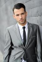 Young businessman near a office building photo