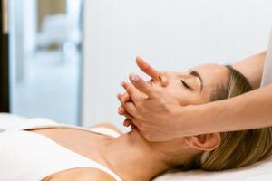 Middle-aged woman having a head massage in a beauty salon. photo