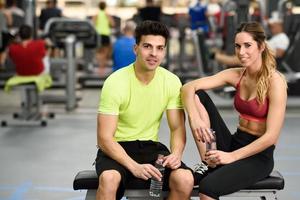Man and woman drinking water after workout photo