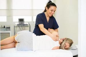 Physiotherapist inspecting her patient in a physiotherapy center.