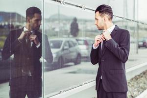 Young businessman near a office building photo