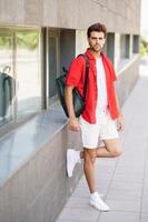 Fashionable man standing outdoors wearing casual clothes photo