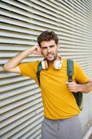 Young man with headphones in urban background photo