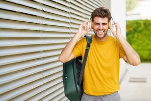 Young man with headphones in urban background photo