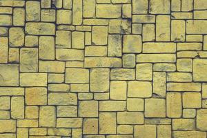 abstract yellow stone wall realistic texture ornament building rock on nature pattern bright. photo