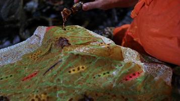 Close Up hand to make batik tulis on the fabric with canting photo