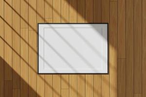 Horizontal black poster or photo frame mockup hanging on the wall with window shadow. 3D rendering.