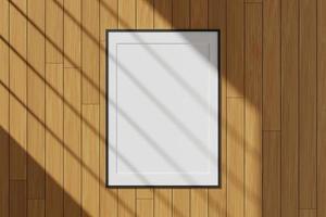 Vertical black poster or photo frame mockup hanging on the wall with window shadow. 3D rendering.