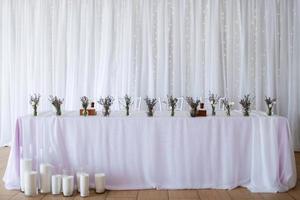 presidium of the newlyweds in the banquet hall of the restaurant photo