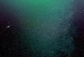 background of abstract galaxies with stars and planets with green galaxy motif of night light universe photo