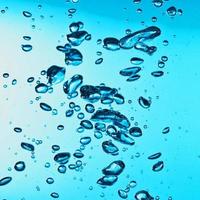 blue transparent water wave splash abstract with water bubbles on blue.