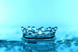 light blue transparent water wave surface with splash bubble on blue. photo