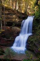 beautiful waterfall panoramic beautiful deep and black rock green natural forest on nature. photo