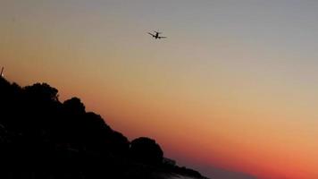 Airplane at most beautiful colorful sunset Ialysos Beach Rhodes Greece. video