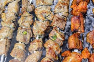 Russian shashlik with skewers on a round grill. photo