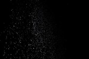 the white particles on black background representing a snowfall. Snow overlay footage for giving a freezing or winter effect to the video presentation. photo