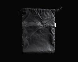 a transparent plastic bag isolated on black background. empty or blank plastic for mockup and template. layout for advertisement or promotion. photo