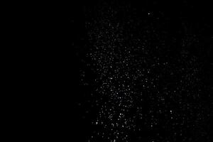 the white particles on black background representing a snowfall. Snow overlay footage for giving a freezing or winter effect to the video presentation. photo