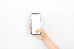 holding a smartphone using two hands like it's typing a chat. a smartphone with a blank white screen used for advertising mockup. photo