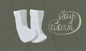light gray knitted warm socks and the inscription stay warm on a gray-green background. contours of legs and plank floor. warm concept vector