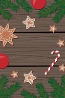 christmas background consisting of spruce branches red gingerbread balls in the form of stars and candy canes on wooden brown boards top view vector