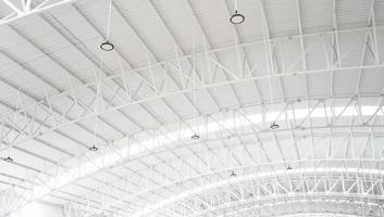 a steel roof in a giant building. a high white roof that is most suitable for industrial buildings. a giant construction with iron material. photo
