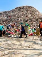 Ponorogo, Indonesia 2021 - People sorting and collecting in landfill. photo