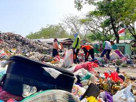 Ponorogo, Indonesia 2021 - People sorting and collecting in landfill photo