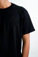 t-shirt mockup in black color. a man wearing a t-shirt for a mockup clothing catalog. mockup graphic from the front view. photo