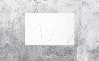 horizontal glued paper on the aged grey wall. wrinkled texture surface can be used for mockup poster, campaign, promotion in street theme. realistic shabby 3d texture illustration. photo
