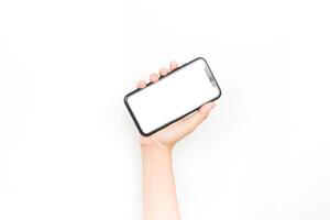 holding a smartphone using two hands like it's typing a chat. a smartphone with a blank white screen used for advertising mockup. photo