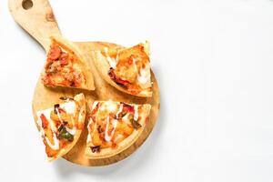 some slices of pizza on the wooden paddle on white. a baked Italian food with tempting topping for advertisement or element design. photo