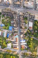 Top view of commercial building and crowded village and car on the alley in suburban photo