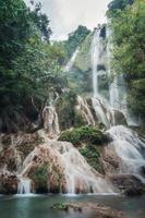 Erawan waterfall 7th floor with water flowing in tropical rainforest at national park photo