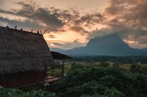 View of wooden hut and mountain view in the sunset at Chiang Dao