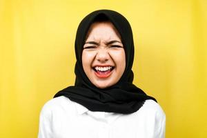 Closeup of beautiful young muslim woman screaming, surprised, shocked, isolated photo