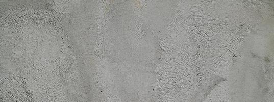 Gray cement plaster. Wall texture for background. Brush scratches on the wall photo