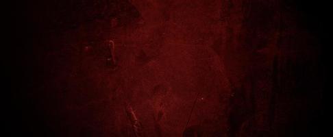 Paredes de color rojo oscuro de miedo, textura de cemento de hormigón oscuro ligeramente claro para el fondo foto
