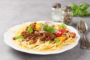 Spaghetti Bolognaise topped with minced beef photo