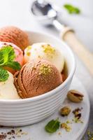 Assorted ice cream in white bowl.