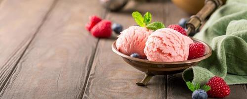 Raspberry ice cream in copper bowl.